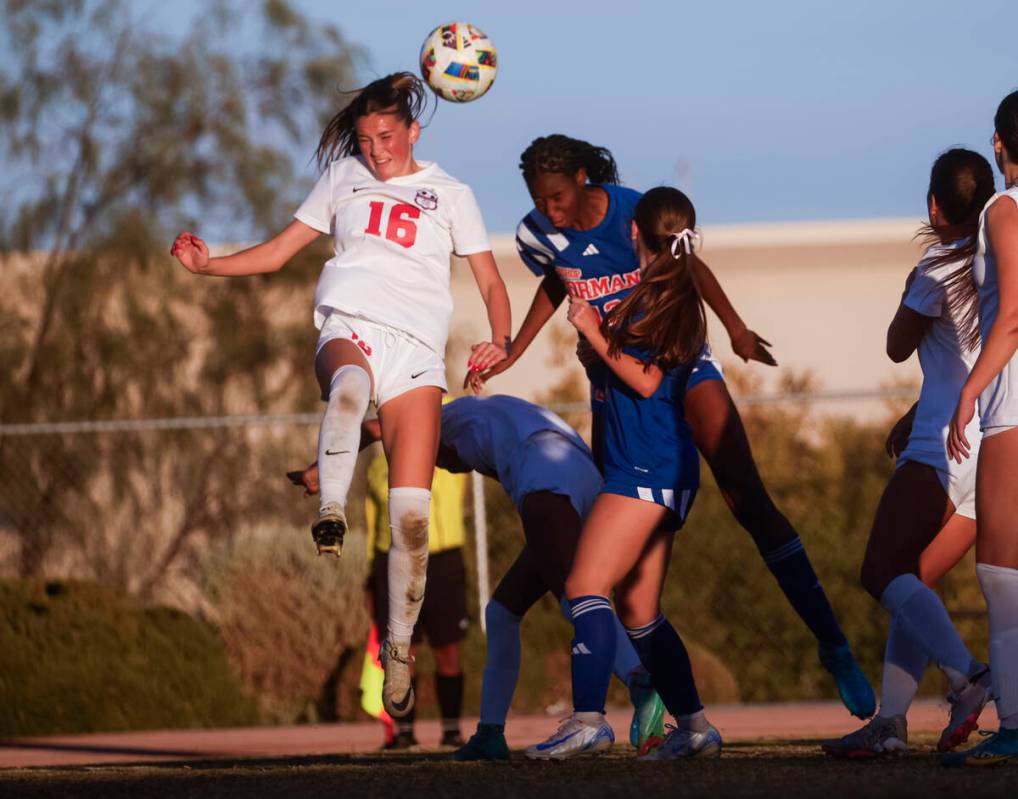 Bishop Gorman midfielder Amiya Warner (12) jumps to head the ball against Coronado defender Mia ...