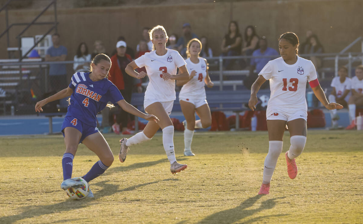 Bishop Gorman midfielder Gianna Tomasello (4) kicks the ball under pressure from Coronado midfi ...