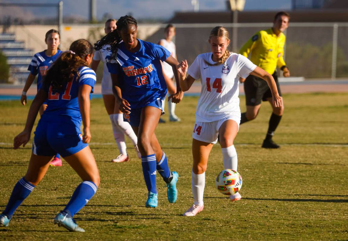 Coronado’s Allison Kleiner (14) kicks the ball under pressure from Bishop Gorman midfiel ...