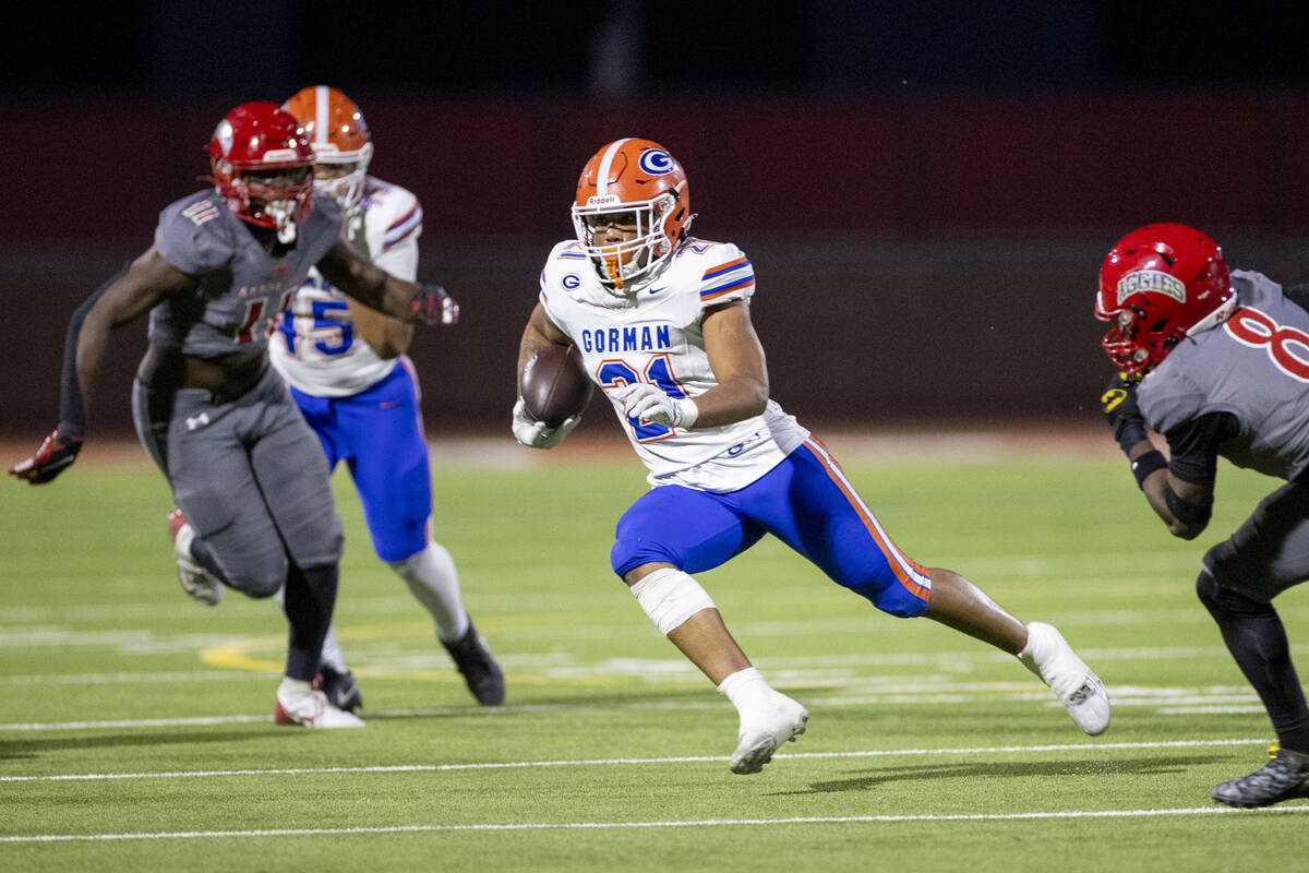 Bishop Gorman running back Jonathan Coar (21) runs the ball during the high school football gam ...