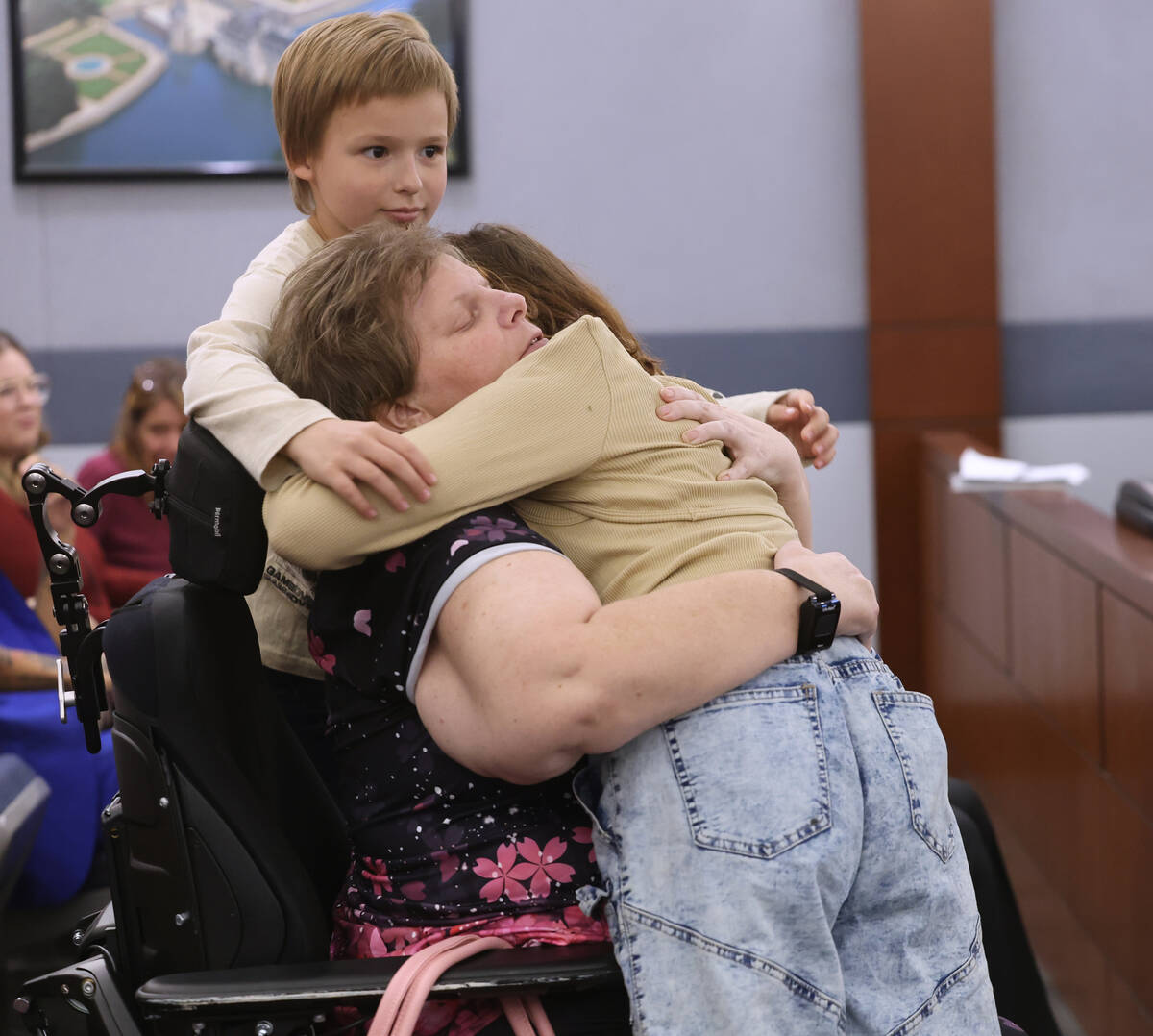 Amber Reedy hugs her daughter Isabella McPherson, 12, and son Roman Ferris, 9, after Isabella g ...