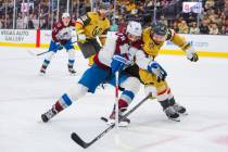 Golden Knights defenseman Nicolas Hague (14) and Colorado Avalanche left wing Miles Wood (28) b ...