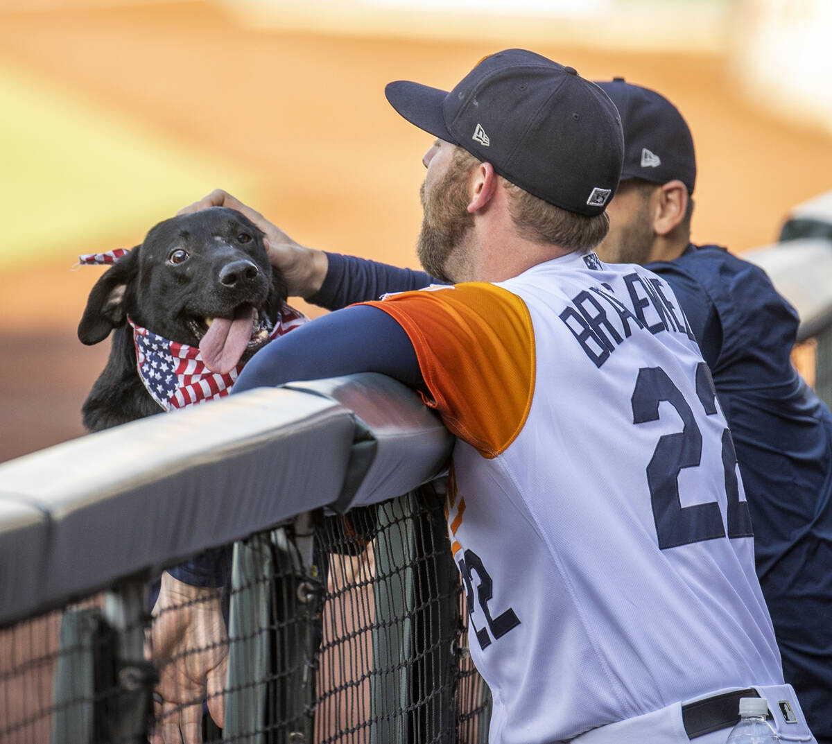 Aviators Ben Bracewell (22) greets Finn the Bat Dog at the Aviators game in the Las Vegas Ballp ...