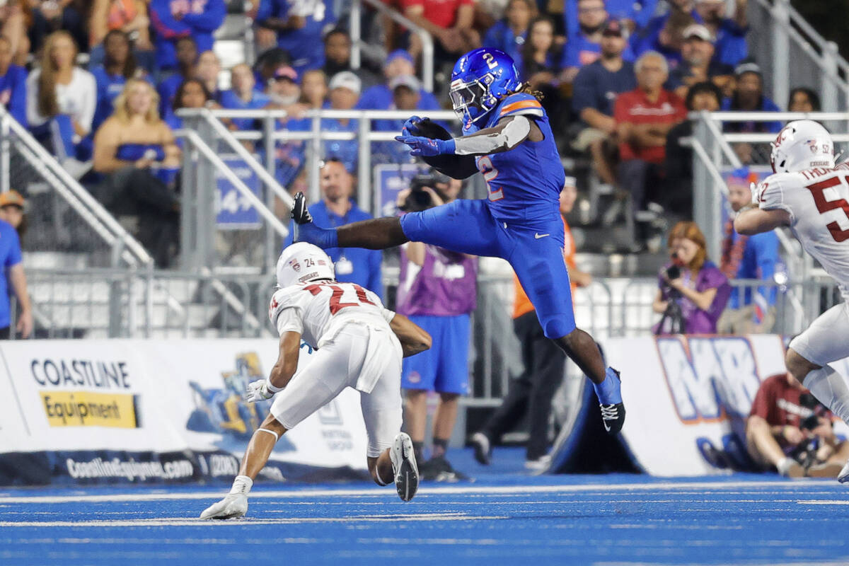 Boise State running back Ashton Jeanty (2) hurdles Washington State defensive back Ethan O'Conn ...