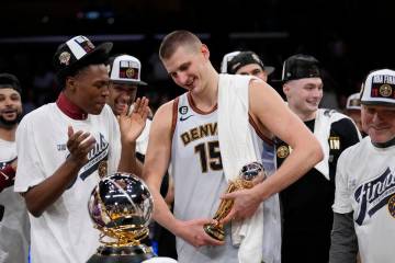 Denver Nuggets center Nikola Jokic holds the series MVP trophy after Game 4 of the NBA basketba ...