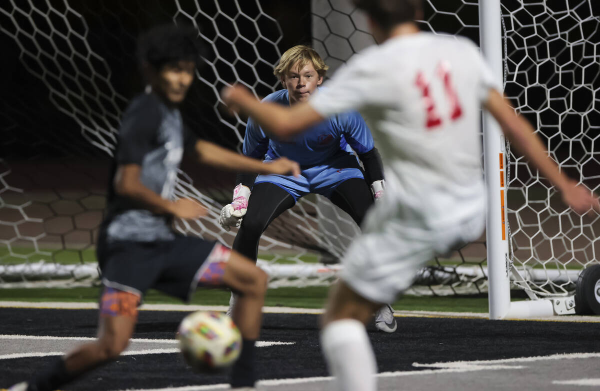 Palo Verde goalkeeper Landon Blanchard keeps his eye on the ball as Coronado's Gavin Flickinger ...