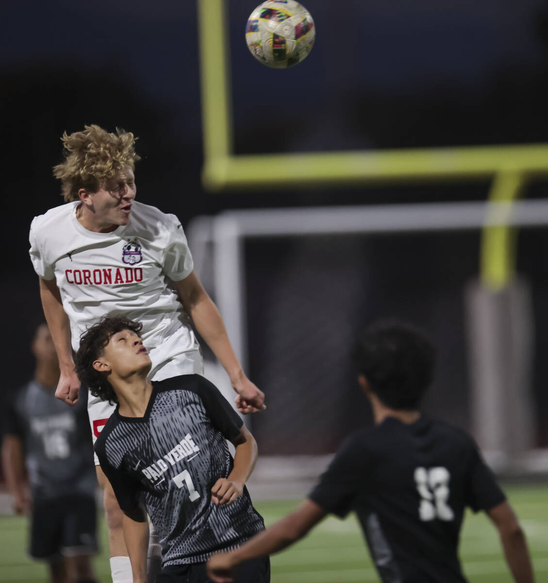 Coronado's Ben Aronow heads the ball above Palo Verde’s Aaron Perez (7) during a soccer ...