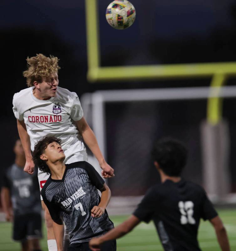 Coronado's Ben Aronow heads the ball above Palo Verde’s Aaron Perez (7) during a soccer ...