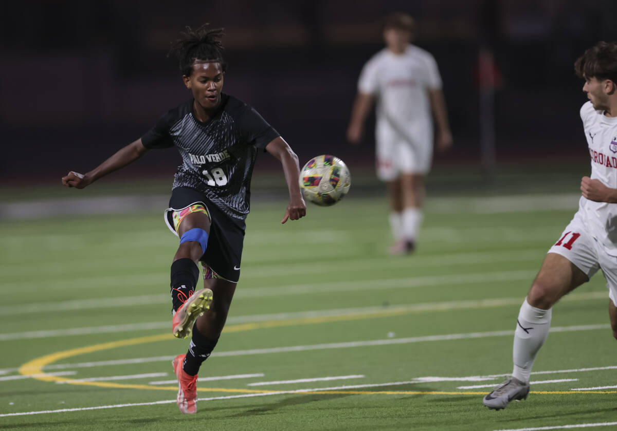 Palo Verde's Shilo Stephenson (18) kicks the ball in front of Coronado's Gavin Flickinger (11) ...