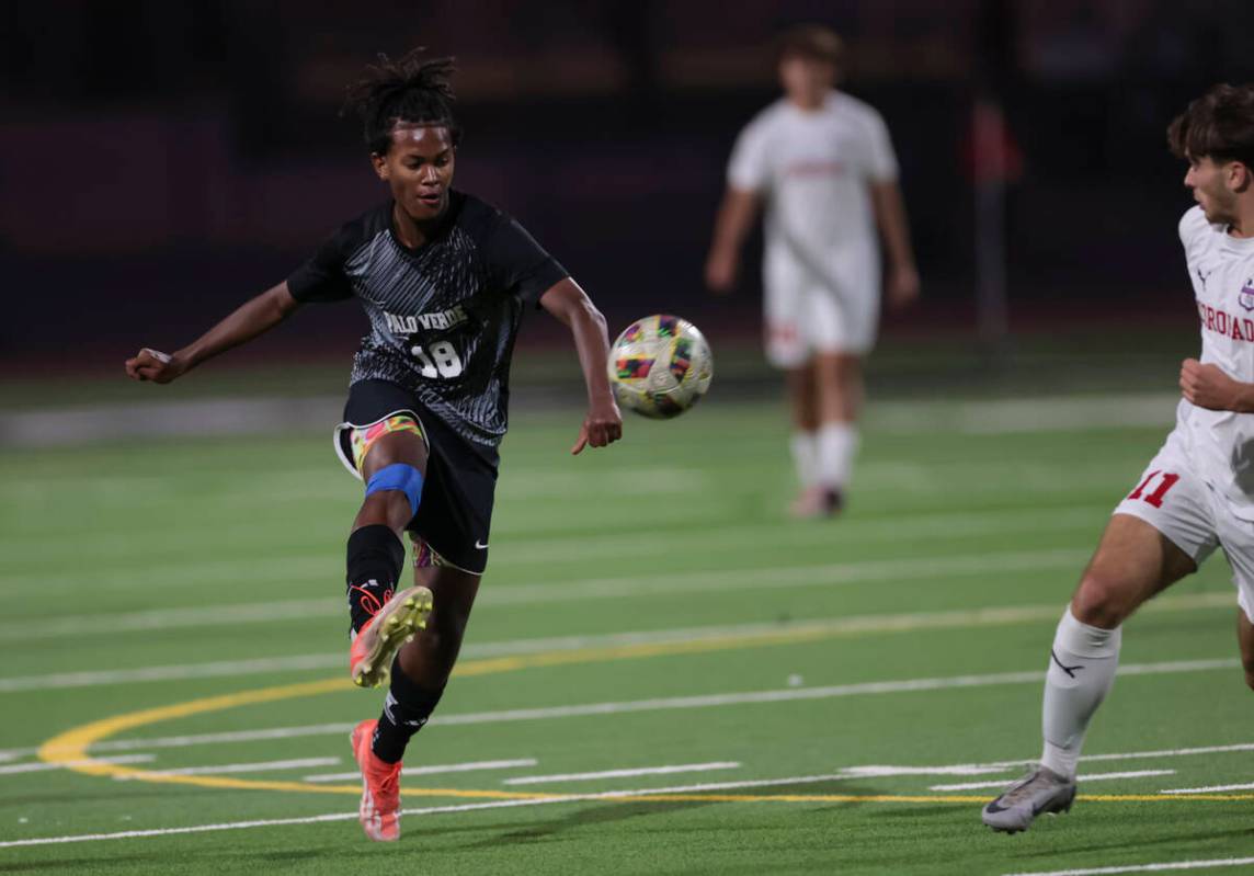 Palo Verde's Shilo Stephenson (18) kicks the ball in front of Coronado's Gavin Flickinger (11) ...