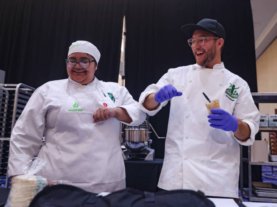 Monse Valencia, 17, from Rancho High School, bumps elbows with Chef Eli Seidman as she competes ...