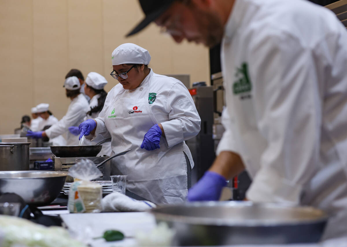 Monse Valencia, 17, from Rancho High School, competes in the School Meal Cooking Challenge at t ...