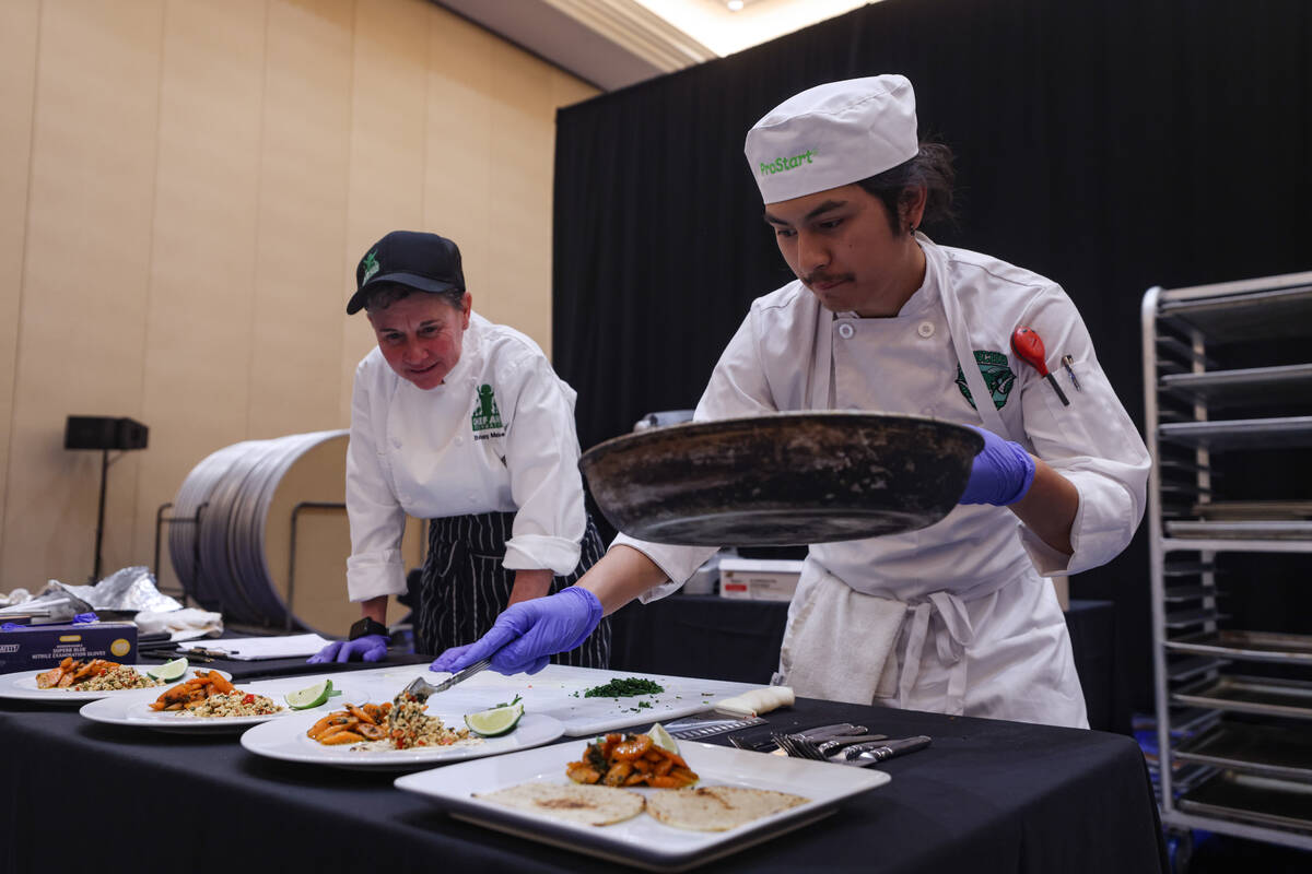 Prinz Villagracia, 17, from Rancho High School, plates his meal as Chef Bethany Markee looks o ...