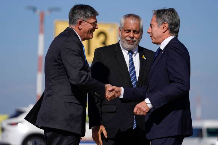 US Secretary of State Antony Blinken (R) is greeted by US Ambassador to Israel Jack Lew (L) and ...