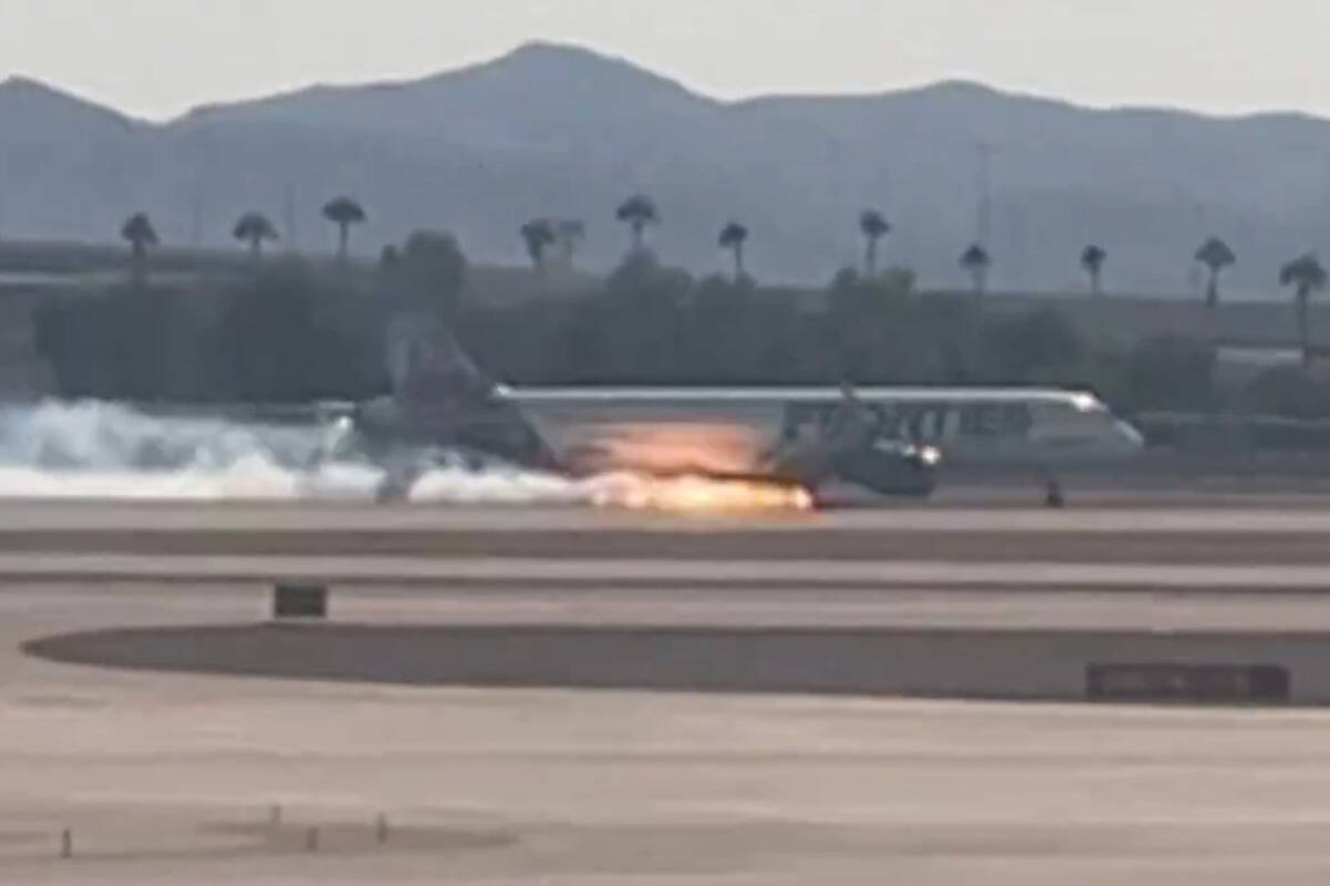 Flames and smoke are seen coming from a Frontier Airlines plane that landed at Harry Reid Inter ...