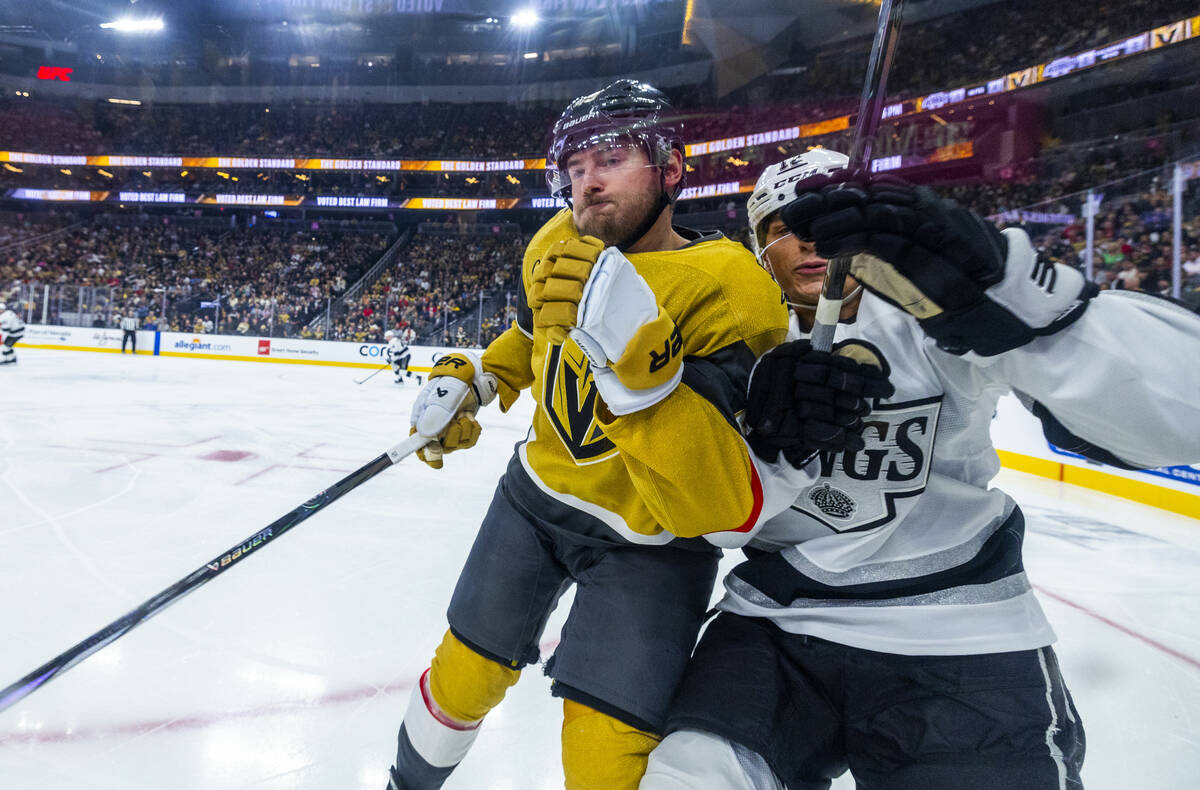 Golden Knights defenseman Zach Whitecloud (2) checks Los Angeles Kings left wing Trevor Moore ( ...