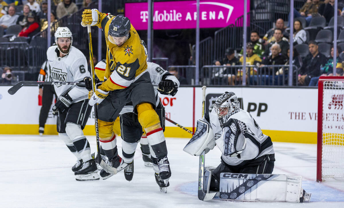 Golden Knights center Brett Howden (21) leaps to deflect a shot at Los Angeles Kings goaltender ...