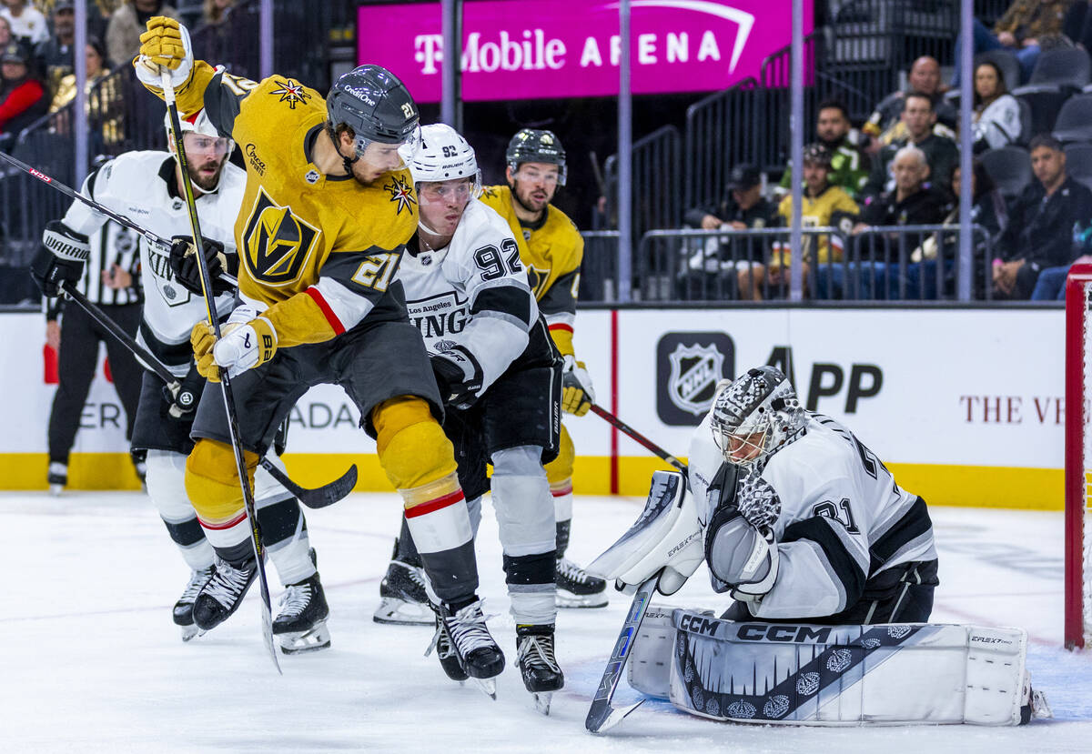 Golden Knights center Brett Howden (21) leaps to deflect a shot at Los Angeles Kings goaltender ...