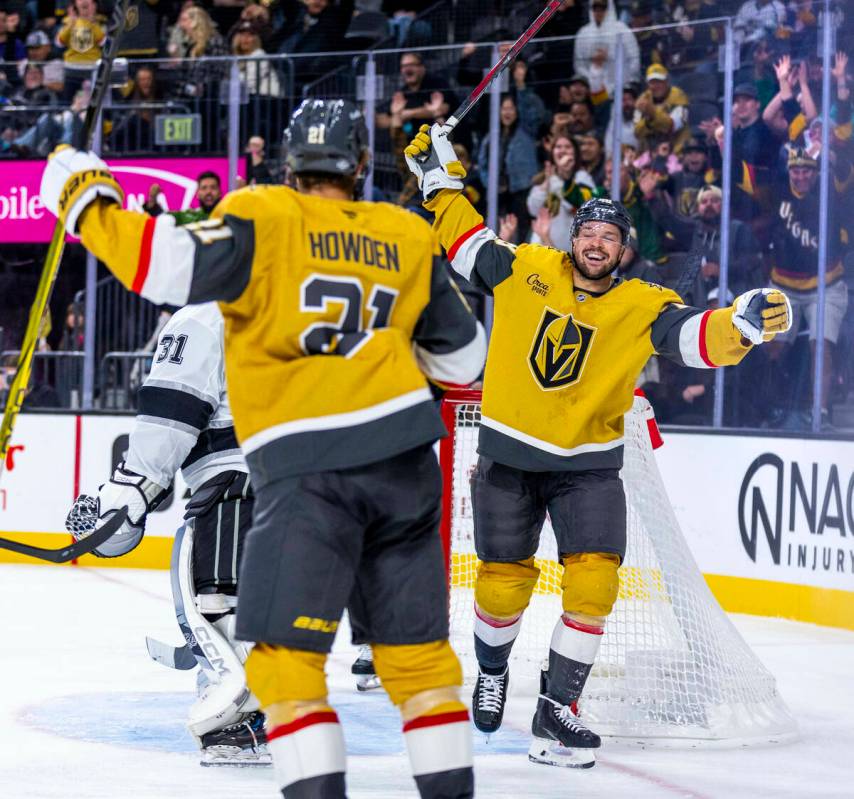 Golden Knights center Tomas Hertl (48) celebrates with center Brett Howden (21) after sneaking ...