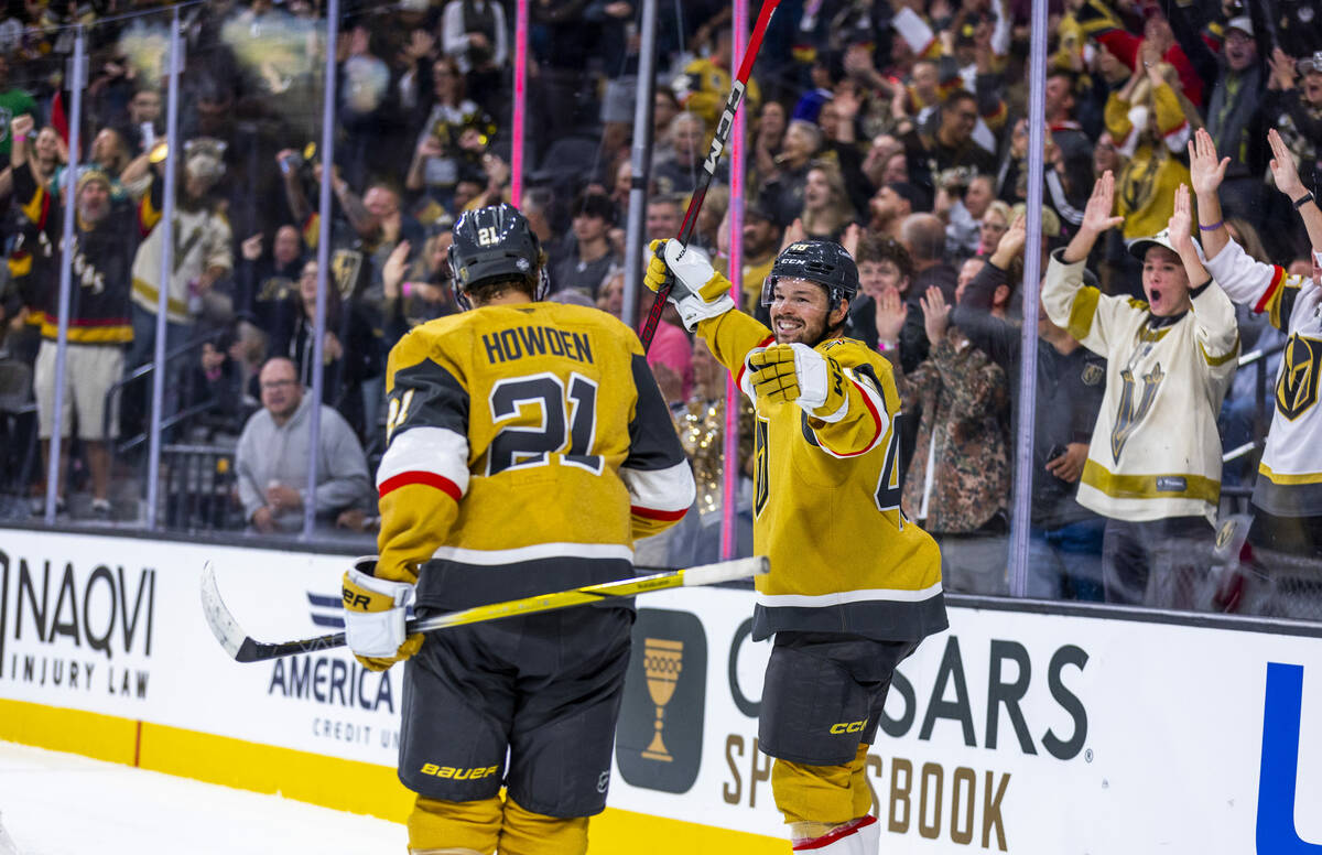 Golden Knights center Tomas Hertl (48) celebrates with center Brett Howden (21) after sneaking ...