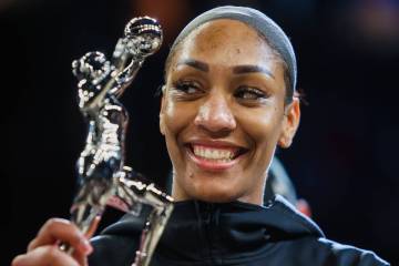 Aces center A'ja Wilson holds up her WNBA MVP trophy before game one of a WNBA playoff game bet ...