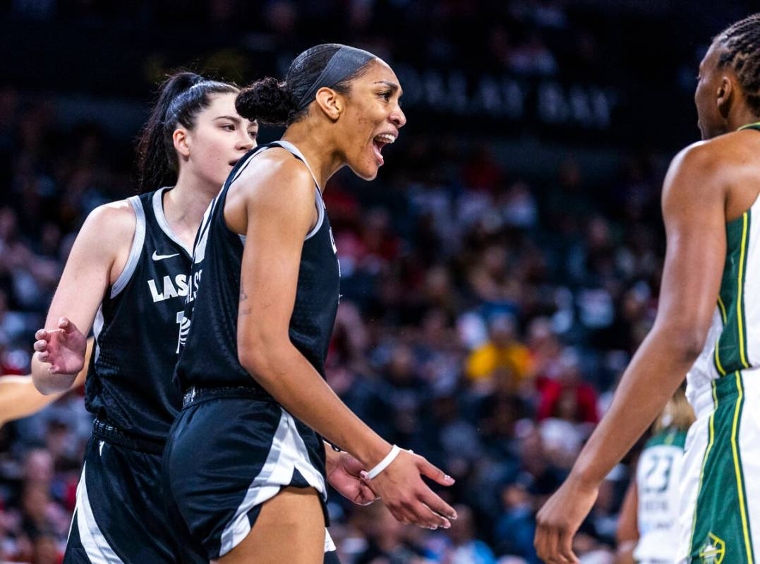 Aces center A'ja Wilson (22) yells about being fouled on the drive by Seattle Storm guard Jorda ...