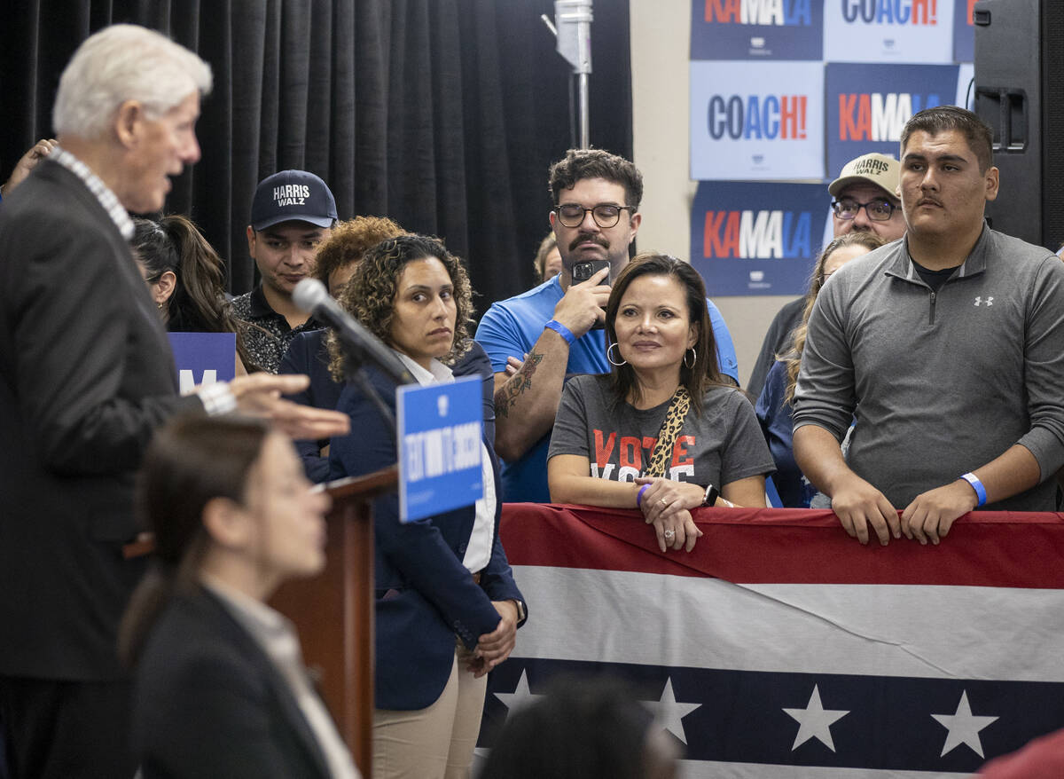 Attendees listen to former President Bill Clinton speak during a Harris-Walz campaign stop at t ...