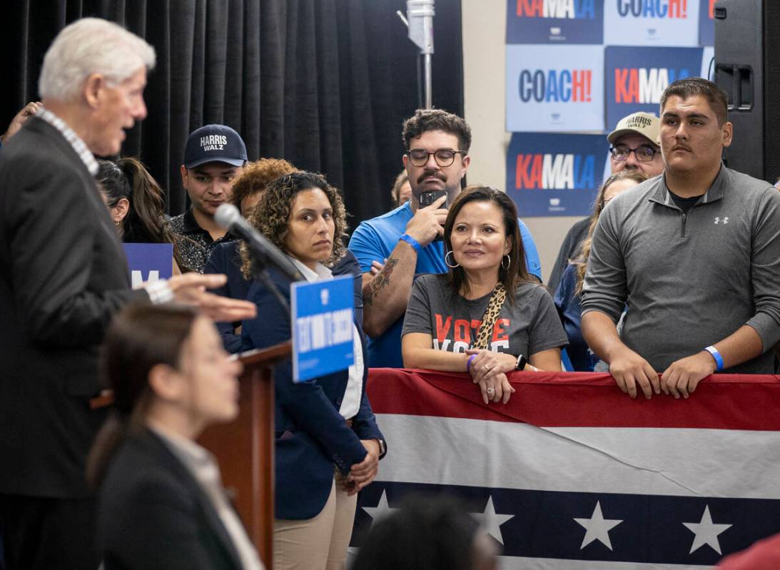 Attendees listen to former President Bill Clinton speak during a Harris-Walz campaign stop at t ...