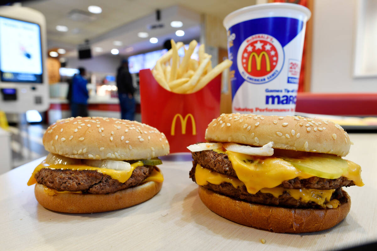 In this March 6, 2018, file photo, a McDonald's Quarter Pounder, left, and Double Quarter Pound ...