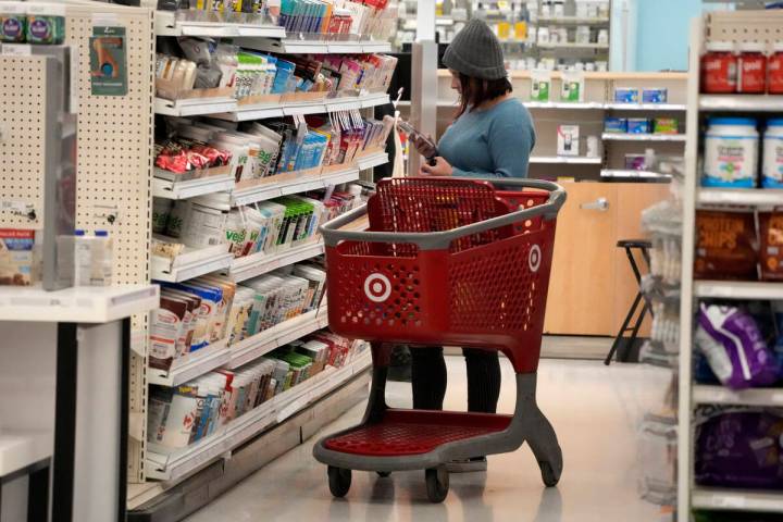 A shopper checks out an item in a Target store in Pittsburgh on Monday, Jan. 23, 2023. (AP Phot ...