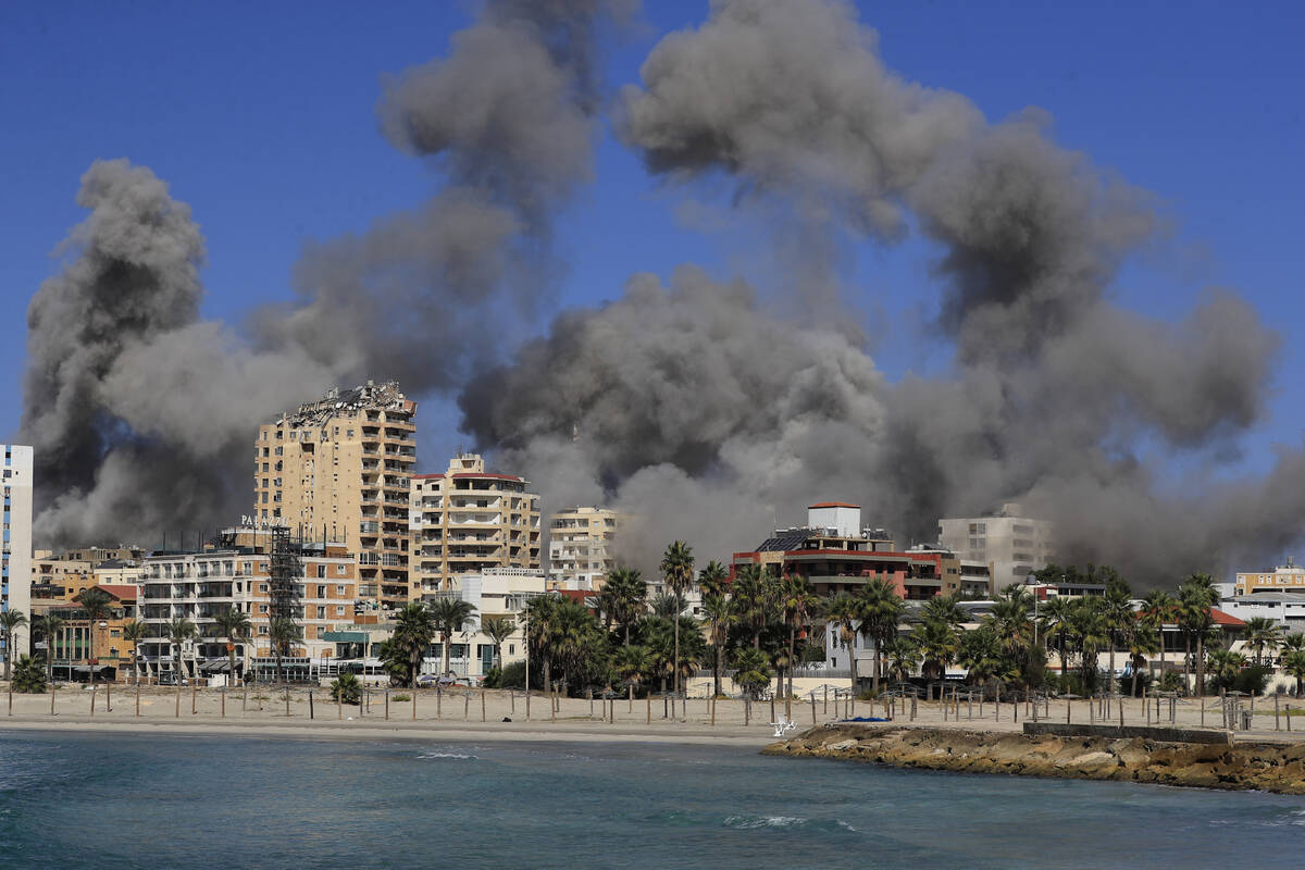 Smoke rises from buildings hit in Israeli airstrikes in Tyre, Lebanon, Wednesday, Oct. 23, 2024 ...