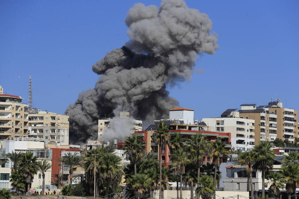 Smoke rises from buildings hit in an Israeli airstrike in Tyre, Lebanon, Wednesday, Oct. 23, 20 ...