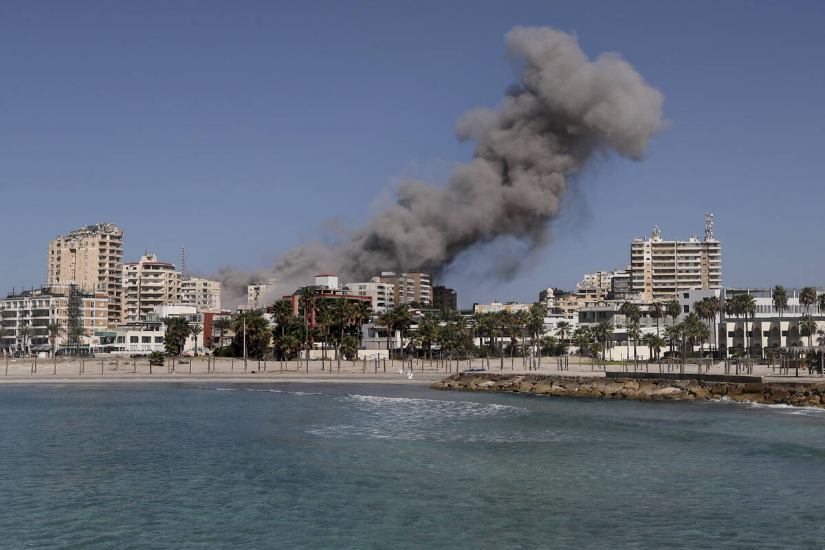 Smoke rises from buildings hit in an Israeli airstrike in Tyre, Lebanon, Wednesday, Oct. 23, 20 ...