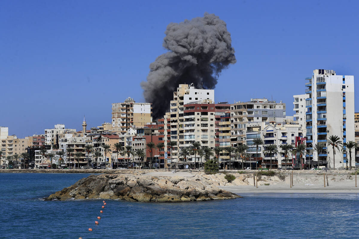 Smoke rises from buildings hit in an Israeli airstrike in Tyre, Lebanon, Wednesday, Oct. 23, 20 ...