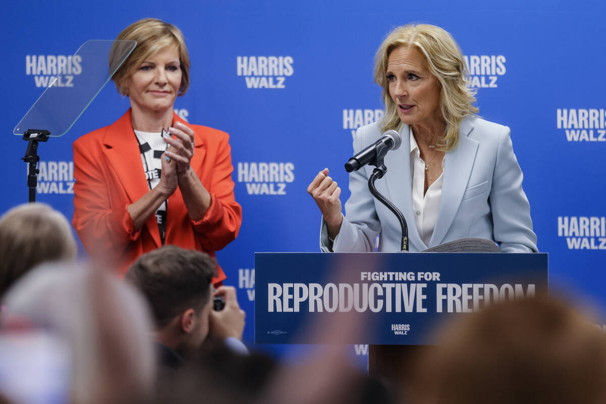 First lady Jill Biden addresses the audience next to Rep. Susie Lee, D-Nev., left, and Padma La ...