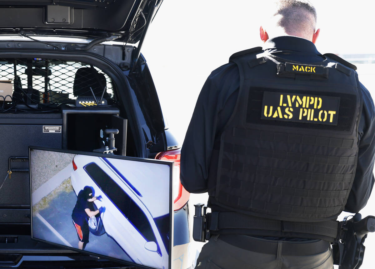 Joshua Mack, Unmanned Aerial Systems (UAS) pilot, flies a Skydio X10 drone over someone playing ...