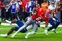 UNLV quarterback Hajj-Malik Williams (6) looks to the end zone as Fresno State Bulldogs defensi ...