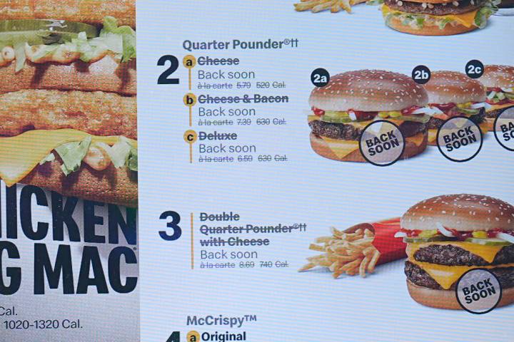 The electronic menu order board still displays Quarter Pounder hamburgers but with a prompt to ...