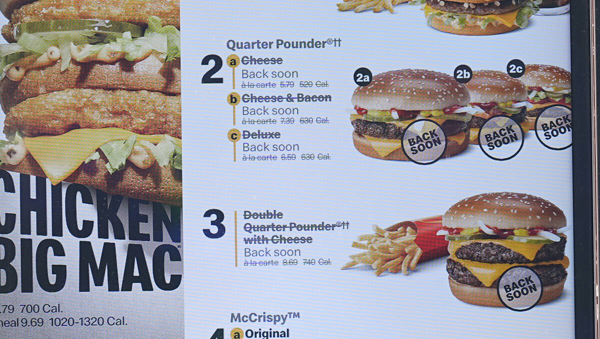 The electronic menu order board still displays Quarter Pounder hamburgers but with a prompt to ...