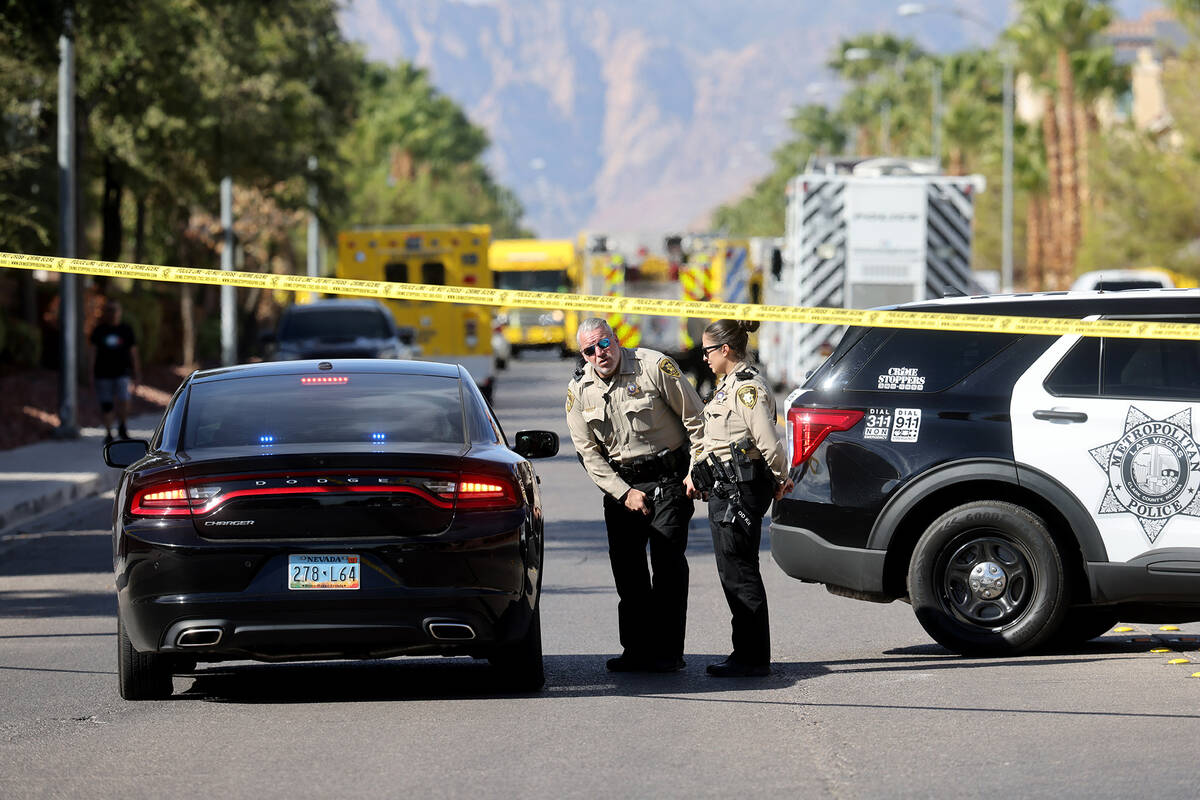 Clark County firefighters and Metropolitan Police Department officers work at the scene of a ho ...