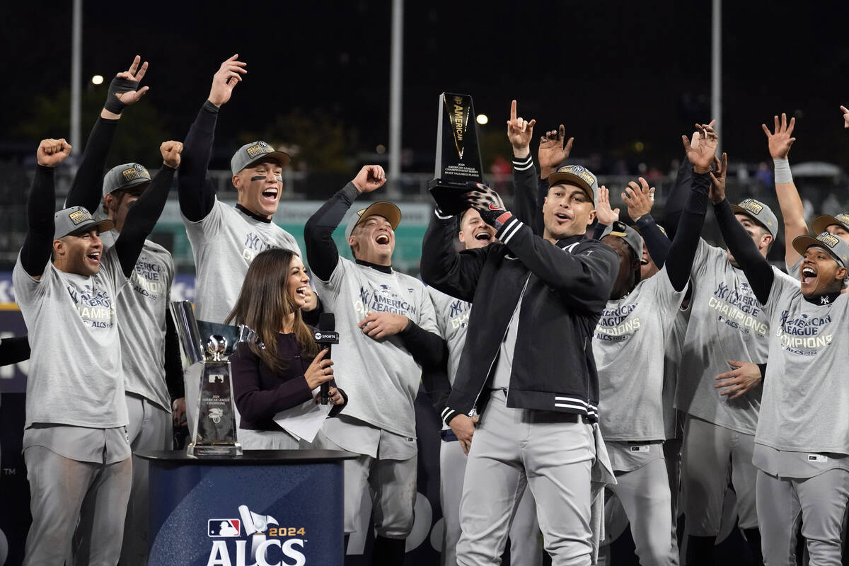 New York Yankees' Giancarlo Stanton holds up the MVP trophy after Game 5 of the baseball AL Cha ...