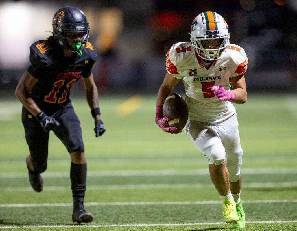 Mojave senior Miguel Reinares (5) runs a reception to the end zone during the high school 4A De ...