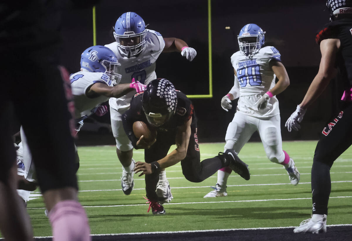 Las Vegas quarterback Tanner Vibabul (8) runs the ball to gain yardage against Centennial durin ...