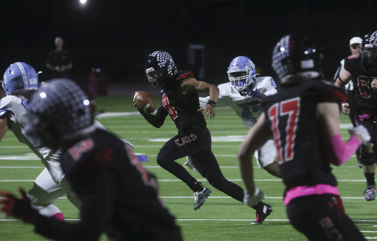 Las Vegas quarterback Tanner Vibabul (8) runs the ball against Centennial during a football gam ...