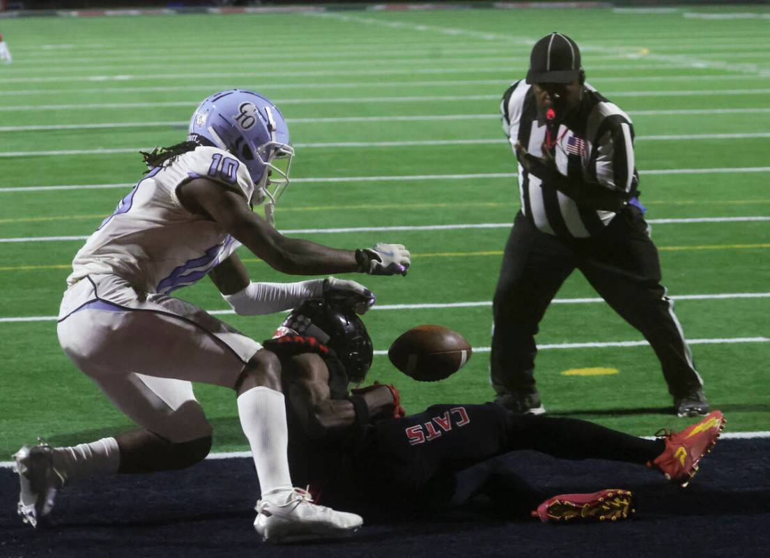 Las Vegas' Mychael Walker (6) comes up short on a reception under pressure from Centennial's Be ...