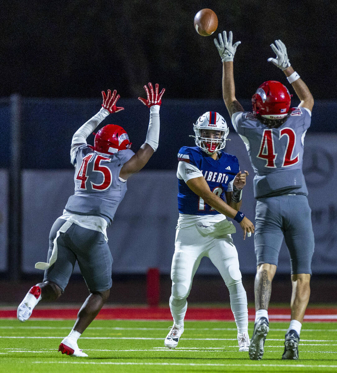 Liberty quarterback Elijah Espinoza (12) releases a pass as Arbor View linebacker Christian Tha ...