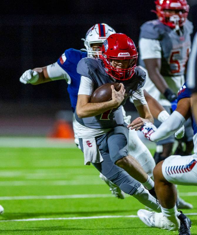 Arbor View quarterback Thaddeus Thatcher (7) looks for more yards on a run as Liberty defenders ...