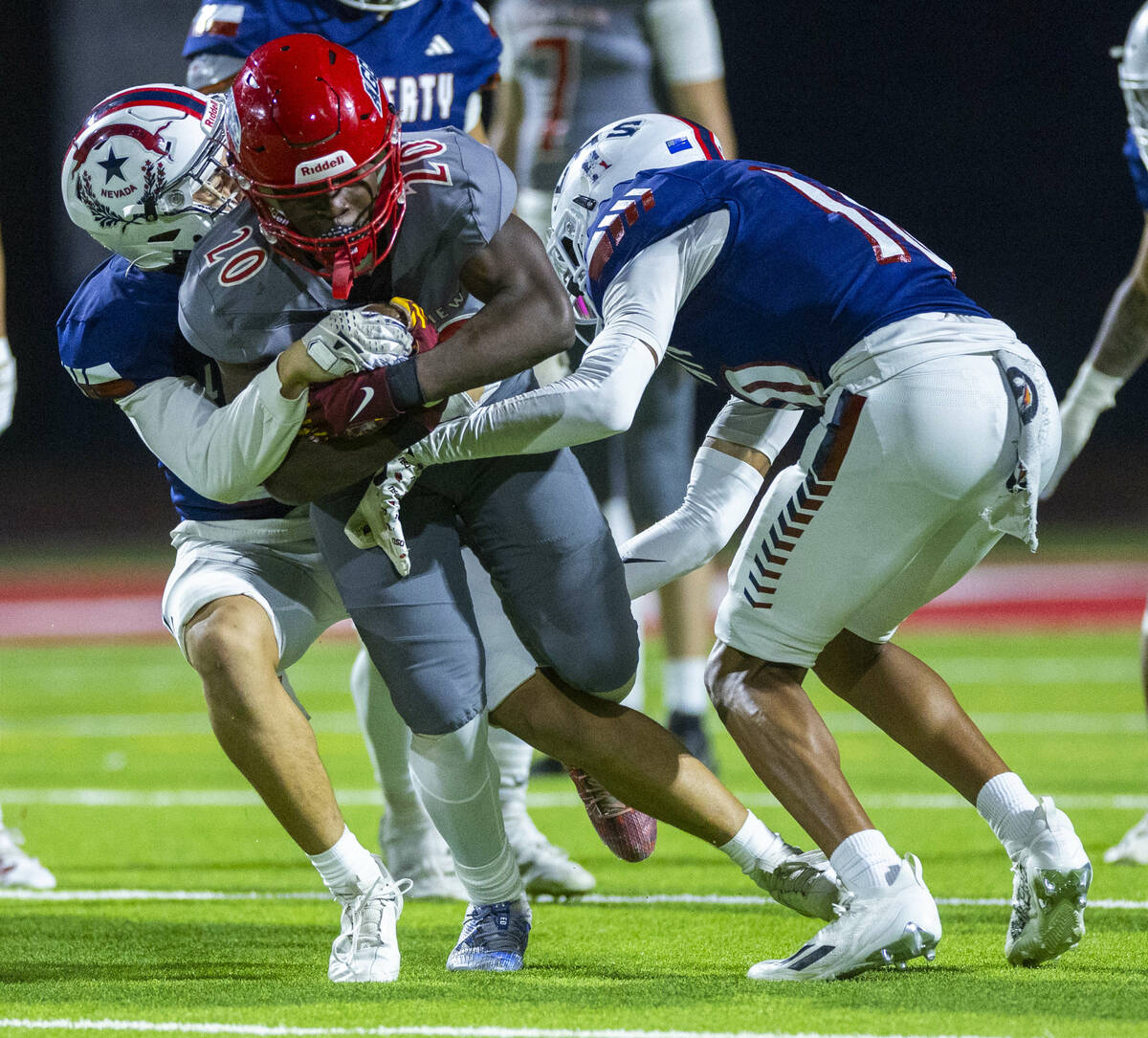 Arbor View running back Kamareion Bell (20) looks for yards as Liberty defenders attempt to mak ...