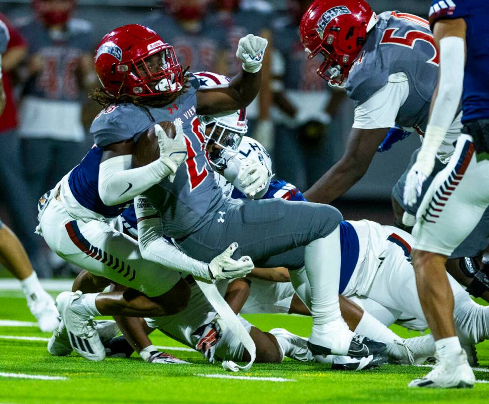 Arbor View running back Kamareion Bell (20) fights for a few more yards against Liberty defende ...