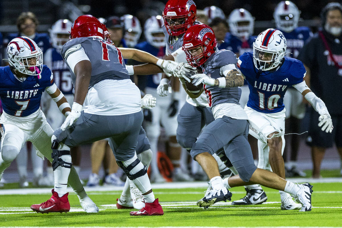 Arbor View wide receiver Jayden Williams (6) gets past Liberty defensive back (10) for more yar ...